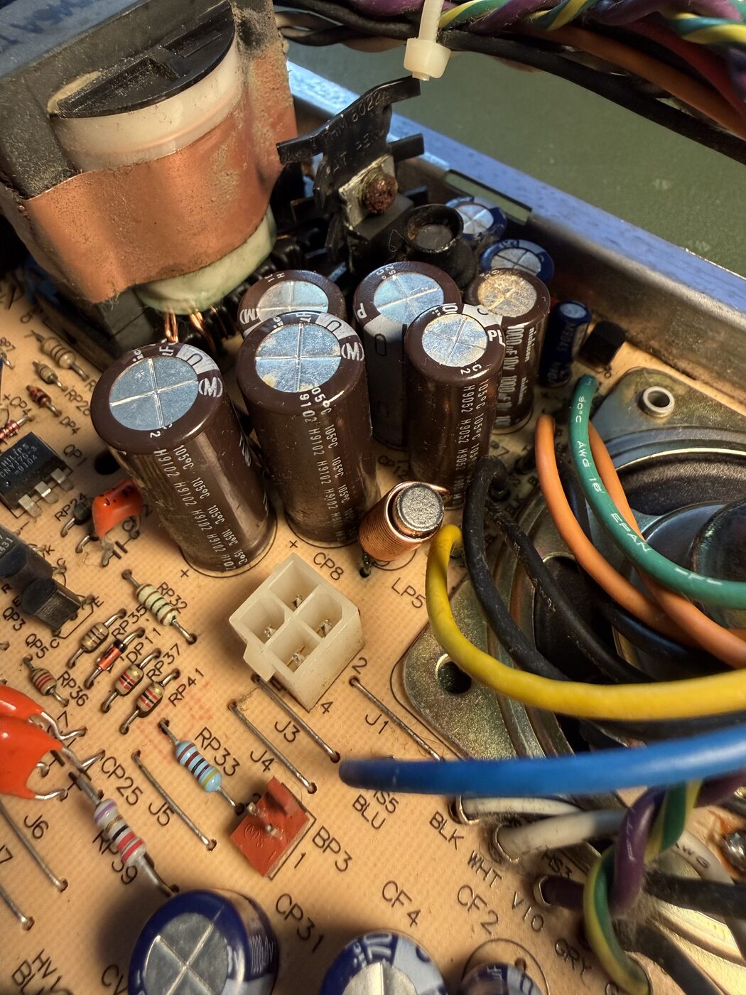 Close-up of the aging electrolytic capacitors on the Mac Classic's analog board